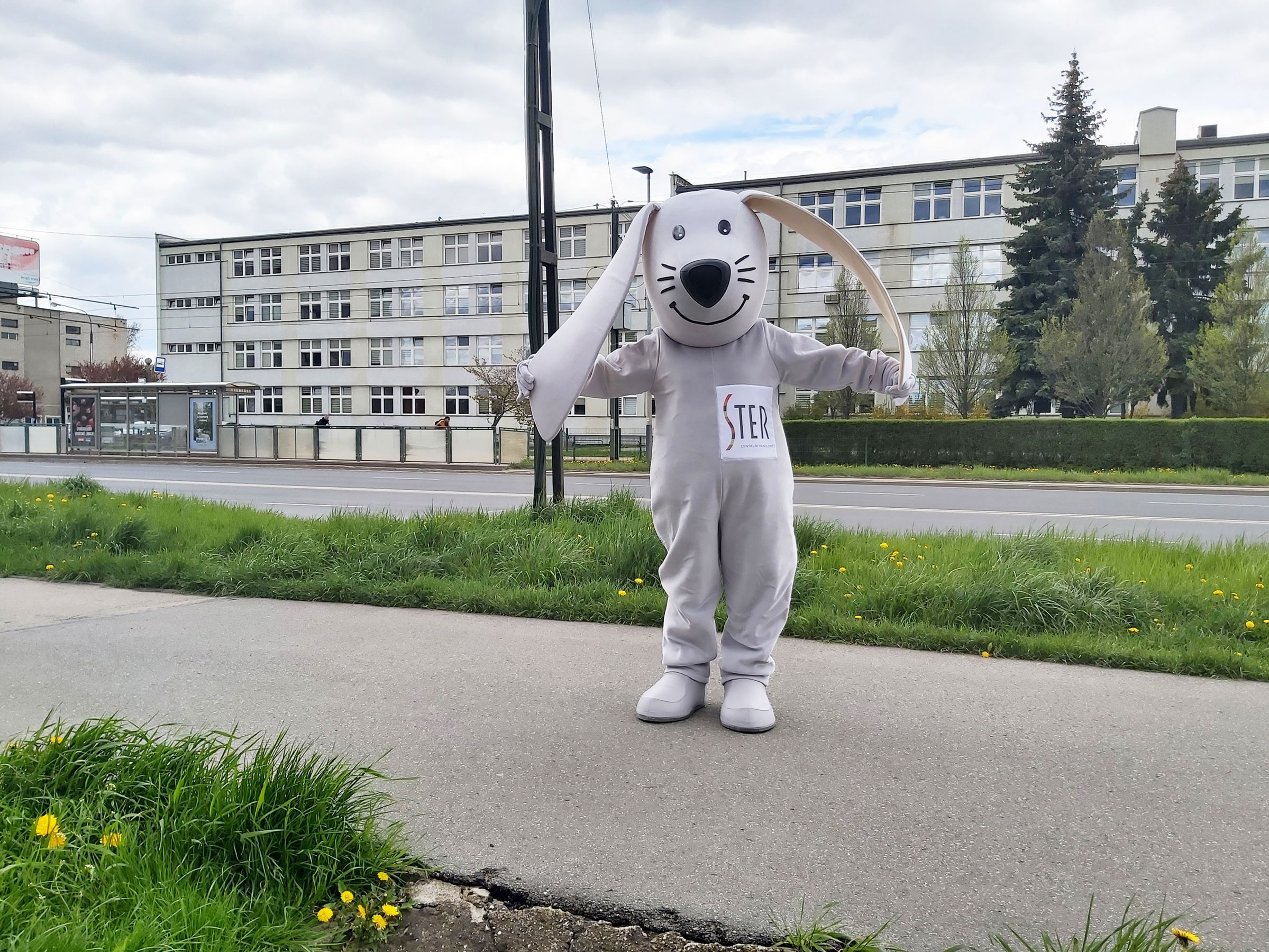Na fotografii widnieje przebranie reklamowe za zająca pozujące do zdjęcia przed siedzibą firmy Elabika